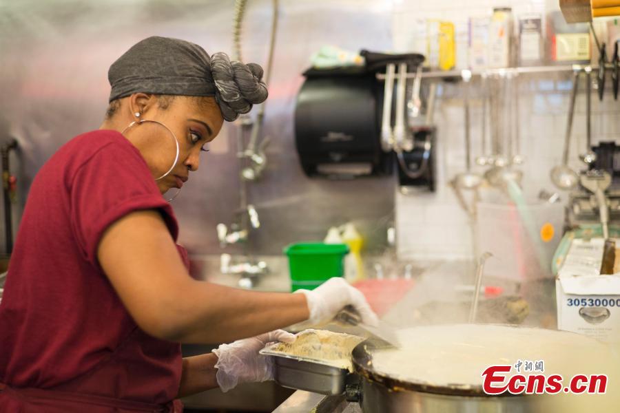 A worker makes Jianbing, or the Chinese crepe at a kiosk in a food court in Brooklyn, New York, the United States on November 10, 2018. The Chinese snack ranges in cost from $13 to $15. (Photo: China News Service/ Liao Pan)