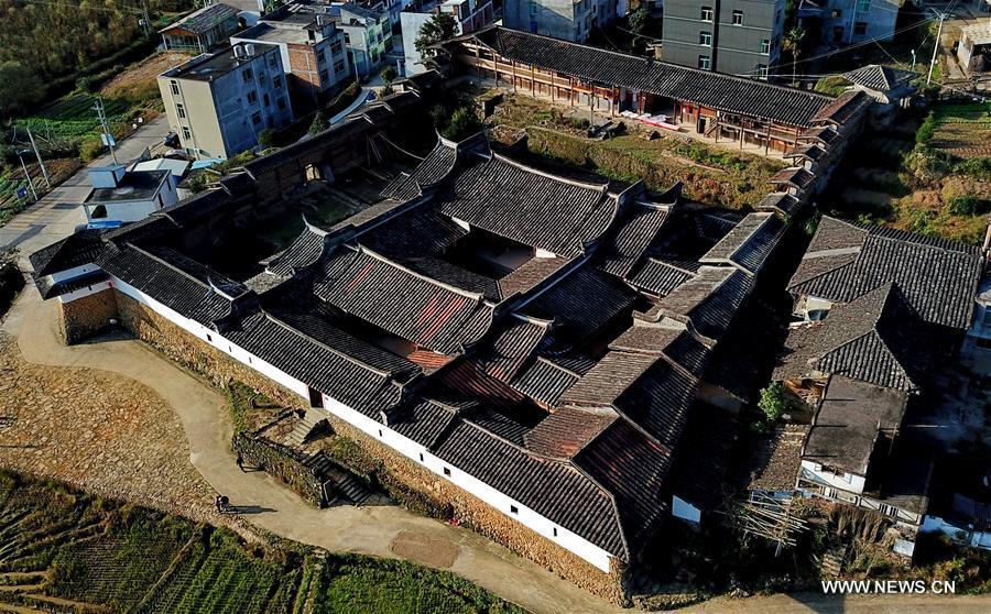 Aerial photo taken on Nov. 11, 2018 shows the scenery of Aijing Zhuang residential complex in Yangwei Village of Yongtai County, southeast China\'s Fujian Province. The project, with a total of 361 rooms covering the area of over 5,200 square meters, was built during the reign of Emperor Daoguang in the Qing Dynasty. It has safeguarded the authentic character of the vernacular housing, defensive structures and waterways that are emblematic of this site, providing a model for other historic villages across China. The conservation of Aijing Zhuang residential complex demonstrates a sensitive approach to sustaining a rural settlement as a living place in harmony with its natural setting. Aijing Zhuang in November this year received the Award of Merit in the 2018 UNESCO Asia-Pacific Awards for Cultural Heritage Conservation. (Xinhua/Zhang Guojun)