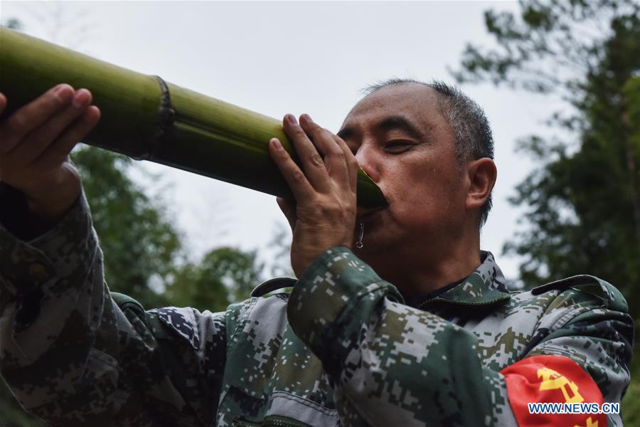 Forest ranger Tang Xiaoping drinks in a bamboo forest at Hushi forestry farm in Chishui City, southwest China\'s Guizhou Province, Oct. 24, 2018. Chishui is famous for its bamboo forest. To guard the bamboo, forest rangers need to patrol for all year round. At the Hushi forestry farm, there is a patrol group consisting of a dozen of forest rangers. They are in charge of about an area of 2,400 hectares. Loneliness is one of the difficulties they need to face as they can only go back home after one-week work. But all of them stay to keep working after those years as they love the bamboo forest and are determined to guard it. (Xinhua/Li Mangmang)