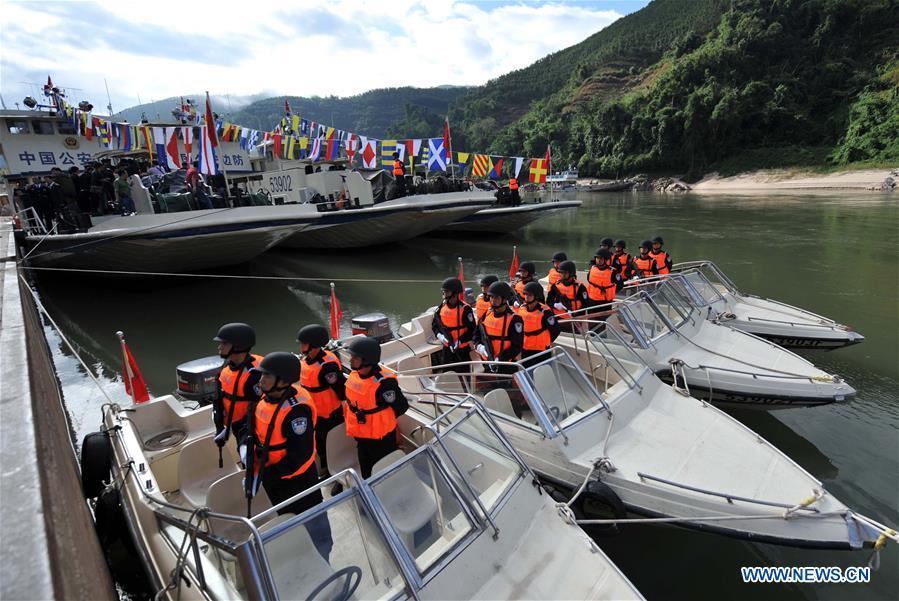 Fully armored Chinese police officers line up as their patrol missions along the Mekong River starts in Guanlei, Dai Autonomous Prefecture of Xishuangbanna, southwest China\'s Yunnan Province, Dec. 9, 2011. The 76th Mekong River joint patrol led by China, Laos, Myanmar, and Thailand started Nov. 20, 2018 from Guanlei Port, Xishuangbanna Dai Autonomous Prefecture in southwest China\'s Yunnan Province. According to Yunnan border police bureau, the joint patrol will last five days and cover a range of over 500 kilometers to enhance anti-terrorism capability, safeguard the security and crack down on cross-border crimes. Once every month since 2011, the patrols targeting drug trafficking, smuggling and other cross-border crimes along the Mekong, conduct random inspections in waters near key regions, including the Golden Triangle.The Mekong River, known as the Lancang River at the Chinese stretch, runs through China, Laos, Myanmar, Thailand, Cambodia and Vietnam. It is an important waterway for transnational shipping and a border area known for criminal activities. For seven years, security cooperation between the four countries has been getting closer with joint patrols a regular monthly phenomenon. The patrol includes anti-terrorism drills, police skill practices and anti-drug campaigns. Since December 2011, the joint patrols have covered more than 39,500 kilometers, with 122 merchant ships rescued and 582.28 kilograms of drugs seized. The cooperation has expanded to the cracking down on terrorism and human trafficking, as well as joint search and rescue. (Xinhua/Lin Yiguang)