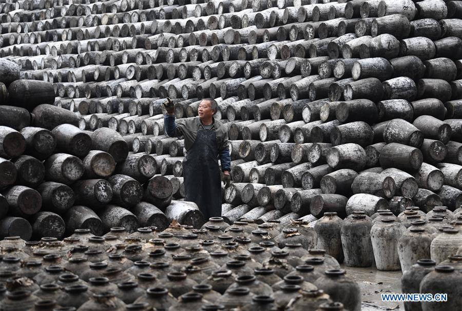 A worker checks the jars used to contain rice wine at Shaoxing Nuerhong Winery Company in Shaoxing, east China\'s Zhejiang Province, Nov. 21, 2018. The company maintains its traditional rice wine brewing method, which is composed of nearly 20 processing steps. (Xinhua/Weng Xinyang)