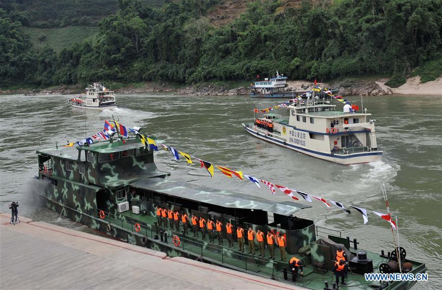 Patrol boats carrying police officers from China, Laos, Myanmar and Thailand leave Guanlei Port in Dai Autonomous Prefecture of Xishuangbanna, southwest China\'s Yunnan Province, as a joint patrol along the Mekong River kicks off on Dec. 10, 2011. The 76th Mekong River joint patrol led by China, Laos, Myanmar, and Thailand started Nov. 20, 2018 from Guanlei Port, Xishuangbanna Dai Autonomous Prefecture in southwest China\'s Yunnan Province. According to Yunnan border police bureau, the joint patrol will last five days and cover a range of over 500 kilometers to enhance anti-terrorism capability, safeguard the security and crack down on cross-border crimes. Once every month since 2011, the patrols targeting drug trafficking, smuggling and other cross-border crimes along the Mekong, conduct random inspections in waters near key regions, including the Golden Triangle.The Mekong River, known as the Lancang River at the Chinese stretch, runs through China, Laos, Myanmar, Thailand, Cambodia and Vietnam. It is an important waterway for transnational shipping and a border area known for criminal activities. For seven years, security cooperation between the four countries has been getting closer with joint patrols a regular monthly phenomenon. The patrol includes anti-terrorism drills, police skill practices and anti-drug campaigns. Since December 2011, the joint patrols have covered more than 39,500 kilometers, with 122 merchant ships rescued and 582.28 kilograms of drugs seized. The cooperation has expanded to the cracking down on terrorism and human trafficking, as well as joint search and rescue. (Xinhua/Lin Yiguang)