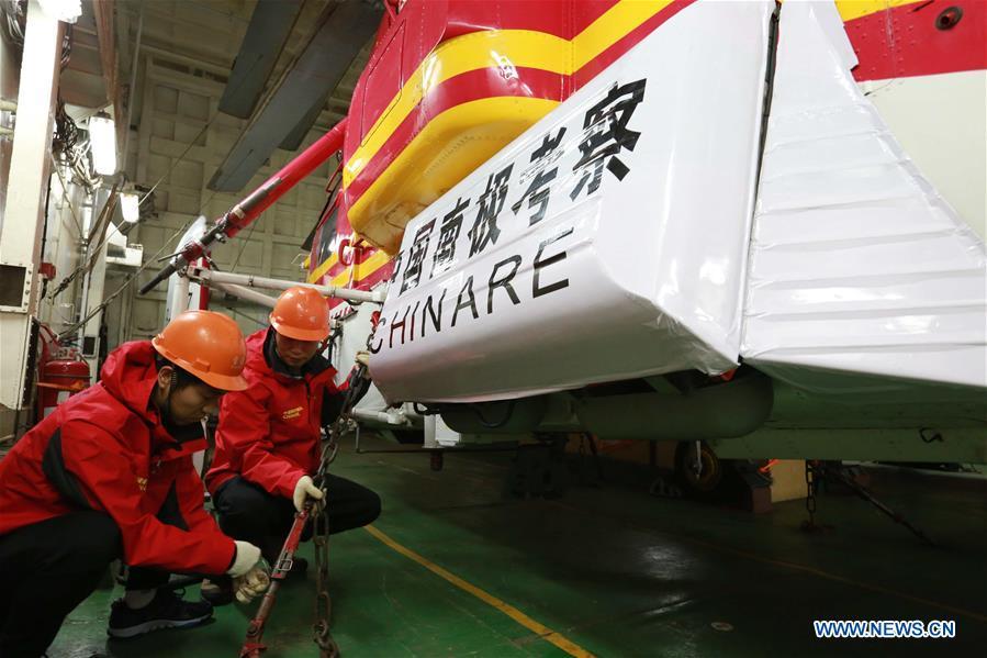 Staff members check a helicopter on China\'s research icebreaker Xuelong, also known as the Snow Dragon, on Nov. 21, 2018. The icebreaker is on China\'s 35th Antarctic research expedition. At 6:22 p.m. Wednesday (local time), Xuelong crossed the stormy westerlies on its way toward China\'s Zhongshan Station in Antarctic. (Xinhua/Liu Shiping)