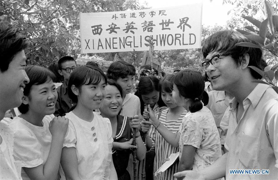 File photo taken in 1985 shows people practicing English in Xi\'an, northwest China\'s Shaanxi Province. From 1978 when China started its reform and opening-up policy, a door to the outside world has been opened. Along with the imported commodities, fashion ideas inevitably slipped into China and since then the country, which was somewhat lack of fashion diversity, started its journey to pursue fashions. Over the past four decades, the thirst for beauty has driven Chinese people to pursue every possible fashionable element. The change first came with dress when colorful and diversified clothing prevailed as against the former dominant blue and grey. For a time, men and women raced to hairdressers\' just for trendy hairdos. Eating McDonald\'s or western cuisine even once was regarded as a fashionable thing. However, the most conspicuous change is that Chinese people have become more inclusive and they tend to accept new fashions, styles and concepts. China nowadays is dazzling the world not only on the fashion stage but in many other fields. Changes in fashions, as a profile of society, has well interpreted the benefits to people brought by China\'s reform and opening-up policy. (Xinhua)