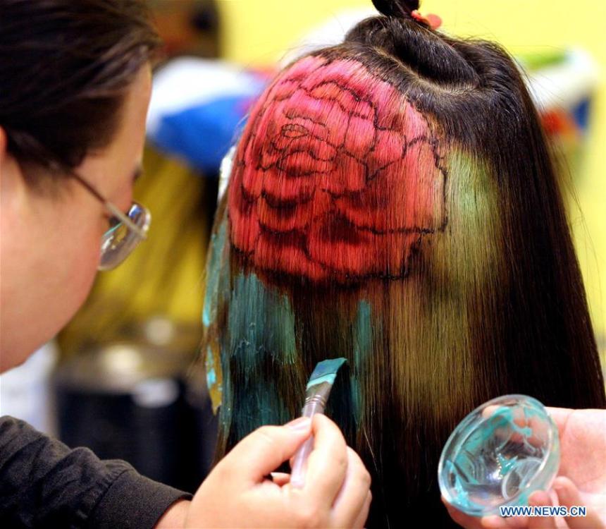File photo taken in April of 2005 shows a young lady having her hair dyed in Luoyang, central China\'s Henan Province. From 1978 when China started its reform and opening-up policy, a door to the outside world has been opened. Along with the imported commodities, fashion ideas inevitably slipped into China and since then the country, which was somewhat lack of fashion diversity, started its journey to pursue fashions. Over the past four decades, the thirst for beauty has driven Chinese people to pursue every possible fashionable element. The change first came with dress when colorful and diversified clothing prevailed as against the former dominant blue and grey. For a time, men and women raced to hairdressers\' just for trendy hairdos. Eating McDonald\'s or western cuisine even once was regarded as a fashionable thing. However, the most conspicuous change is that Chinese people have become more inclusive and they tend to accept new fashions, styles and concepts. China nowadays is dazzling the world not only on the fashion stage but in many other fields. Changes in fashions, as a profile of society, has well interpreted the benefits to people brought by China\'s reform and opening-up policy. (Xinhua)