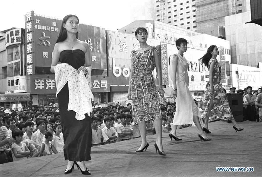 File photo taken in 1995 shows models presenting fashion creations at a shopping mall in Shenyang, northeast China\'s Liaoning Province. From 1978 when China started its reform and opening-up policy, a door to the outside world has been opened. Along with the imported commodities, fashion ideas inevitably slipped into China and since then the country, which was somewhat lack of fashion diversity, started its journey to pursue fashions. Over the past four decades, the thirst for beauty has driven Chinese people to pursue every possible fashionable element. The change first came with dress when colorful and diversified clothing prevailed as against the former dominant blue and grey. For a time, men and women raced to hairdressers\' just for trendy hairdos. Eating McDonald\'s or western cuisine even once was regarded as a fashionable thing. However, the most conspicuous change is that Chinese people have become more inclusive and they tend to accept new fashions, styles and concepts. China nowadays is dazzling the world not only on the fashion stage but in many other fields. Changes in fashions, as a profile of society, has well interpreted the benefits to people brought by China\'s reform and opening-up policy. (Xinhua/Li Yonghong)