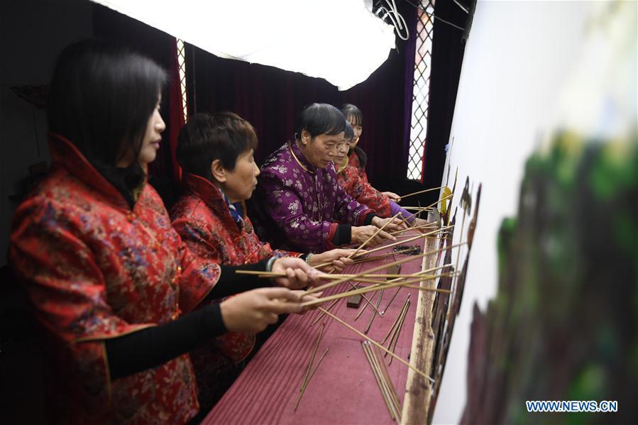 Zhang Kunrong(C) performs with his apprentices in a shadow puppetry show in Haining City, east China\'s Zhejiang Province, Nov. 20, 2018. Zhang Kunrong, 79, a locally born shadow puppetry player, is an inheritor of the Haining shadow puppetry, a form of traditional theatre acted by colorful silhouette figures made from leather or paper, accompanied by music and singing. A typical variety popular in south China, Haining shadow puppetry, a national intangible cultural heritage, has a history of about 900 years dating back to the Southern Song Dynasty (AD 1127-1279). Obsessed with the shadow play since childhood, Zhang Kunrong was recruited to the provincial shadow puppetry troupe in 1958 and soon became a mainstay after two year\'s practice and in the later years staged performances at home and abroad as Haining shadow puppetry grows popular. Nowadays, Zhang works more on script writing, directing and teaching apprentices. Haining shadow puppetry was listed as one of the state-level intangible cultural heritages in 2006 and was included in the UNESCO Intangible Cultural Heritage of Humanity list in 2011. (Xinhua/Huang Zongzhi)