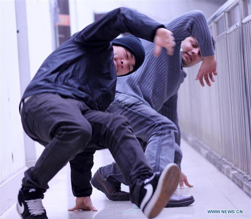 File photo taken on March 11, 2011 shows Abdul Mubeen (back) practicing dance with Wang Yang, a member of the hip-hop team \