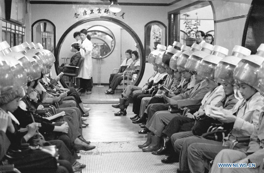 File photo taken in 1982 shows people getting their hair permed at a barber shop in east China\'s Shanghai. From 1978 when China started its reform and opening-up policy, a door to the outside world has been opened. Along with the imported commodities, fashion ideas inevitably slipped into China and since then the country, which was somewhat lack of fashion diversity, started its journey to pursue fashions. Over the past four decades, the thirst for beauty has driven Chinese people to pursue every possible fashionable element. The change first came with dress when colorful and diversified clothing prevailed as against the former dominant blue and grey. For a time, men and women raced to hairdressers\' just for trendy hairdos. Eating McDonald\'s or western cuisine even once was regarded as a fashionable thing. However, the most conspicuous change is that Chinese people have become more inclusive and they tend to accept new fashions, styles and concepts. China nowadays is dazzling the world not only on the fashion stage but in many other fields. Changes in fashions, as a profile of society, has well interpreted the benefits to people brought by China\'s reform and opening-up policy. (Xinhua)