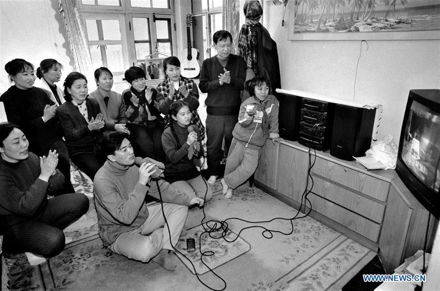 File photo issued on Jan. 20, 1997 shows people singing during a karaoke activity in Jinzhou, northeast China\'s Liaoning Province. From 1978 when China started its reform and opening-up policy, a door to the outside world has been opened. Along with the imported commodities, fashion ideas inevitably slipped into China and since then the country, which was somewhat lack of fashion diversity, started its journey to pursue fashions. Over the past four decades, the thirst for beauty has driven Chinese people to pursue every possible fashionable element. The change first came with dress when colorful and diversified clothing prevailed as against the former dominant blue and grey. For a time, men and women raced to hairdressers\' just for trendy hairdos. Eating McDonald\'s or western cuisine even once was regarded as a fashionable thing. However, the most conspicuous change is that Chinese people have become more inclusive and they tend to accept new fashions, styles and concepts. China nowadays is dazzling the world not only on the fashion stage but in many other fields. Changes in fashions, as a profile of society, has well interpreted the benefits to people brought by China\'s reform and opening-up policy. (Xinhua/Li Yonghong)