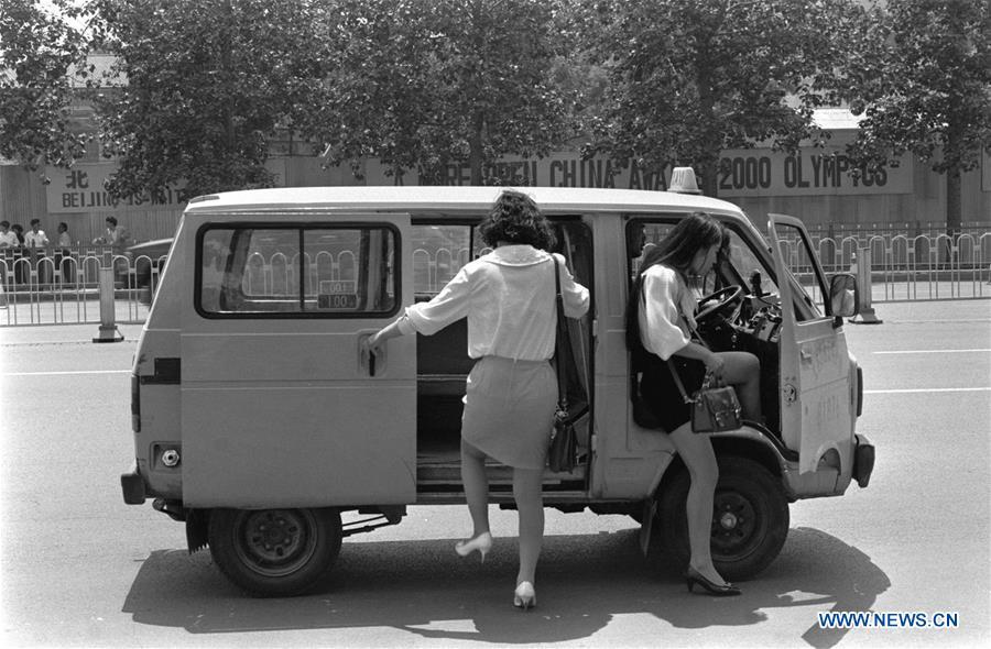 File photo taken in 1993 shows two young ladies getting on a taxi in Beijing, capital of China. From 1978 when China started its reform and opening-up policy, a door to the outside world has been opened. Along with the imported commodities, fashion ideas inevitably slipped into China and since then the country, which was somewhat lack of fashion diversity, started its journey to pursue fashions. Over the past four decades, the thirst for beauty has driven Chinese people to pursue every possible fashionable element. The change first came with dress when colorful and diversified clothing prevailed as against the former dominant blue and grey. For a time, men and women raced to hairdressers\' just for trendy hairdos. Eating McDonald\'s or western cuisine even once was regarded as a fashionable thing. However, the most conspicuous change is that Chinese people have become more inclusive and they tend to accept new fashions, styles and concepts. China nowadays is dazzling the world not only on the fashion stage but in many other fields. Changes in fashions, as a profile of society, has well interpreted the benefits to people brought by China\'s reform and opening-up policy. (Xinhua)