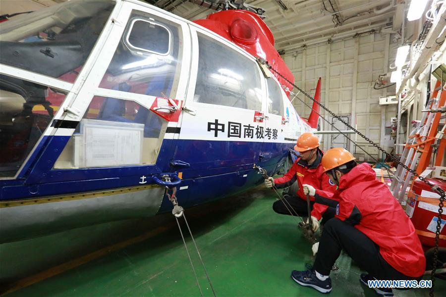 Staff members check a helicopter on China\'s research icebreaker Xuelong, also known as the Snow Dragon, on Nov. 21, 2018. The icebreaker is on China\'s 35th Antarctic research expedition. At 6:22 p.m. Wednesday (local time), Xuelong crossed the stormy westerlies on its way toward China\'s Zhongshan Station in Antarctic. (Xinhua/Liu Shiping)