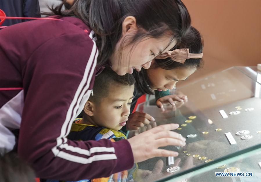 Visitors look at the commemorative coins during a major exhibition to commemorate the 40th anniversary of China\'s reform and opening-up at the National Museum of China in Beijing, capital of China, Nov. 24, 2018. (Xinhua/Yin Gang)
