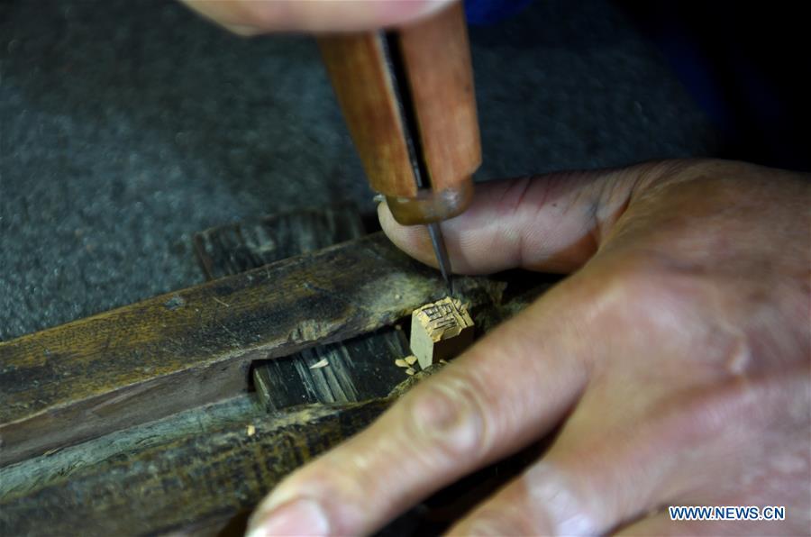 Lei Shitai works in Chanshan Village of Qinxi Town, Jingxian County, in east China\'s Anhui Province, Nov. 23, 2018. Lei, 52, born in neighboring Jiangxi Province, started his career as a typography printer when he finished his apprenticeship with his uncle who he followed since he was 17. The traditional printing method witnessed an increasingly hard time in the recent years as a livelihood. It was in 2017 when he decided to move to Chanshan at the invitation of Kai Yuanhong, a local cabinet maker, to cooperate in a broader way. Lei is now working with the traditional technique in a larger scale. (Xinhua/Liu Junxi)