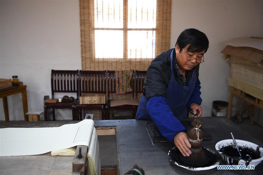 Lei Shitai works in Chanshan Village of Qinxi Town, Jingxian County, in east China\'s Anhui Province, Nov. 23, 2018. Lei, 52, born in neighboring Jiangxi Province, started his career as a typography printer when he finished his apprenticeship with his uncle who he followed since he was 17. The traditional printing method witnessed an increasingly hard time in the recent years as a livelihood. It was in 2017 when he decided to move to Chanshan at the invitation of Kai Yuanhong, a local cabinet maker, to cooperate in a broader way. Lei is now working with the traditional technique in a larger scale. (Xinhua/Zhang Duan)