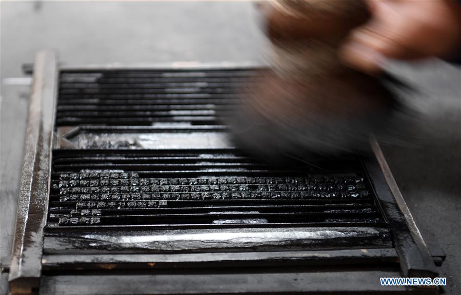Lei Shitai brushes his printing tools in Chanshan Village of Qinxi Town, Jingxian County, in east China\'s Anhui Province, Nov. 23, 2018. Lei, 52, born in neighboring Jiangxi Province, started his career as a typography printer when he finished his apprenticeship with his uncle who he followed since he was 17. The traditional printing method witnessed an increasingly hard time in the recent years as a livelihood. It was in 2017 when he decided to move to Chanshan at the invitation of Kai Yuanhong, a local cabinet maker, to cooperate in a broader way. Lei is now working with the traditional technique in a larger scale. (Xinhua/Zhang Duan)