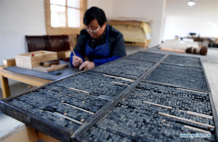 Lei Shitai works in Chanshan Village of Qinxi Town, Jingxian County, in east China\'s Anhui Province, Nov. 23, 2018. Lei, 52, born in neighboring Jiangxi Province, started his career as a typography printer when he finished his apprenticeship with his uncle who he followed since he was 17. The traditional printing method witnessed an increasingly hard time in the recent years as a livelihood. It was in 2017 when he decided to move to Chanshan at the invitation of Kai Yuanhong, a local cabinet maker, to cooperate in a broader way. Lei is now working with the traditional technique in a larger scale. (Xinhua/Liu Junxi)