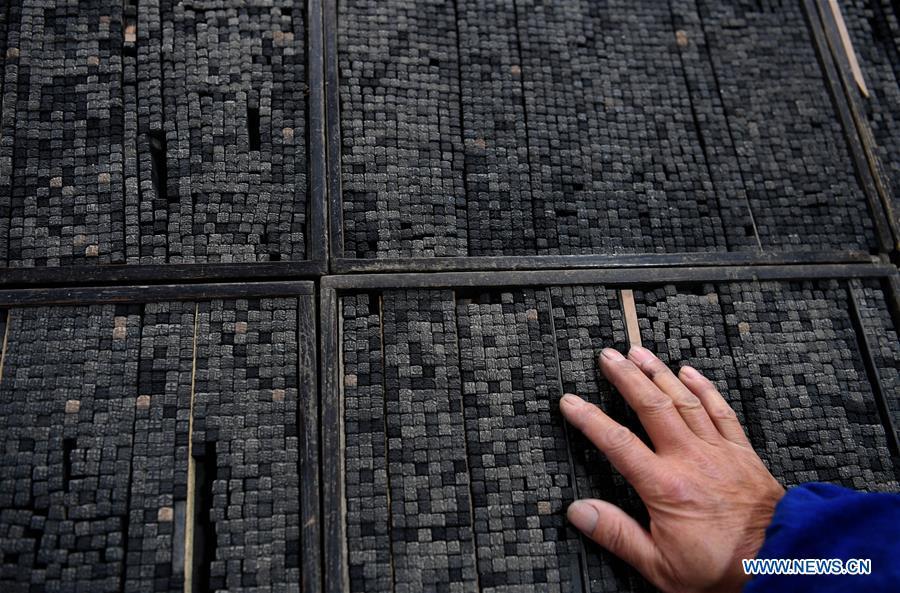 Lei Shitai works in Chanshan Village of Qinxi Town, Jingxian County, in east China\'s Anhui Province, Nov. 23, 2018. Lei, 52, born in neighboring Jiangxi Province, started his career as a typography printer when he finished his apprenticeship with his uncle who he followed since he was 17. The traditional printing method witnessed an increasingly hard time in the recent years as a livelihood. It was in 2017 when he decided to move to Chanshan at the invitation of Kai Yuanhong, a local cabinet maker, to cooperate in a broader way. Lei is now working with the traditional technique in a larger scale. (Xinhua/Liu Junxi)