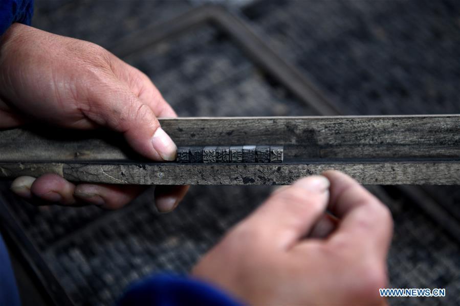 Lei Shitai works in Chanshan Village of Qinxi Town, Jingxian County, in east China\'s Anhui Province, Nov. 23, 2018. Lei, 52, born in neighboring Jiangxi Province, started his career as a typography printer when he finished his apprenticeship with his uncle who he followed since he was 17. The traditional printing method witnessed an increasingly hard time in the recent years as a livelihood. It was in 2017 when he decided to move to Chanshan at the invitation of Kai Yuanhong, a local cabinet maker, to cooperate in a broader way. Lei is now working with the traditional technique in a larger scale. (Xinhua/Liu Junxi)