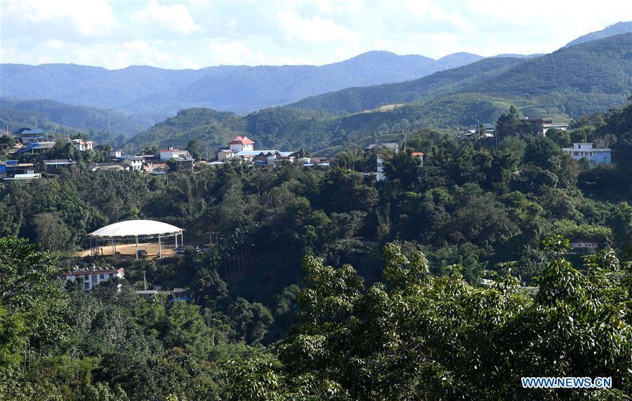 Aerial photo taken on Nov. 20, 2018 shows a view of the Jino Ethnic Township on Jino Mountain in Jinghong of Xishuangbanna Dai Autonomous Prefecture, southwest China\'s Yunnan Province. With a population of slightly over 20,000, the Jino people had only been officially acknowledged in 1979 as an independent ethnic group of China. Until 1949, most of them had lived for generations in primitive mountain tribes in southwest China\'s Yunnan Province. Over the four decades since it embraced the reform and opening-up policy, China has spared no effort to support ethnic groups with smaller populations. Life on Jino Mountain, where most Jino communities are located, saw positive changes in parallel with improvements in local politics, economy, technology, education, culture, health care, ecology, ethnic development and other social undertakings. Just like its 55 ethnic brethren, the Jino people also benefit from China\'s reform and opening-up in seeking a prosperous life. In Jino Ethnic Township on the Jino Mountain, residents now have direct access to road, water, electricity, TV and radio, as well as the mobile network. Ninety percent of the residents have moved into new houses. Most residents own motorcycles and tractors, and some of them have purchased cars. More people have increased their income by selling local specialty products via the internet, whereas in the past, doing business was perceived as a shame. Currently, the primary education in Jino Ethnic Township achieved 100 percent coverage for all school-age children. More than 99 percent of residents have joined the rural cooperative medical insurance programme. The Jino ethnic culture undergoes protection and inheritance: the great drum dance of the Jino people has been listed as one of China\'s national intangible cultural heritages. (Xinhua/Lin Yiguang)