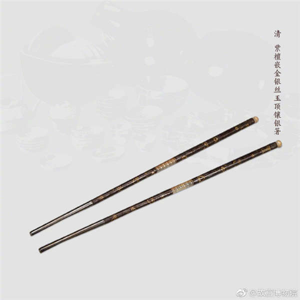 A pair of chopsticks made of red sandalwood inlaid with metallic yarn and jade, from the Qing Dynasty. (Photo/Official Weibo account of the Palace Museum)