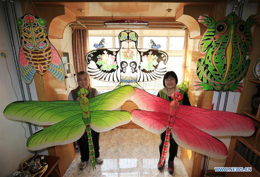 Fu Xianming and his wife display self-made kites in Shijiazhuang, capital of north China\'s Hebei Province, Nov. 21, 2018. Fu Xianming, a 66-year-old craftsman, has devoted himself in kites making for 20 years. Fu and his wife have made more than 1,500 kites of various shapes since 1998. (Xinhua/Zhang Haiqiang)