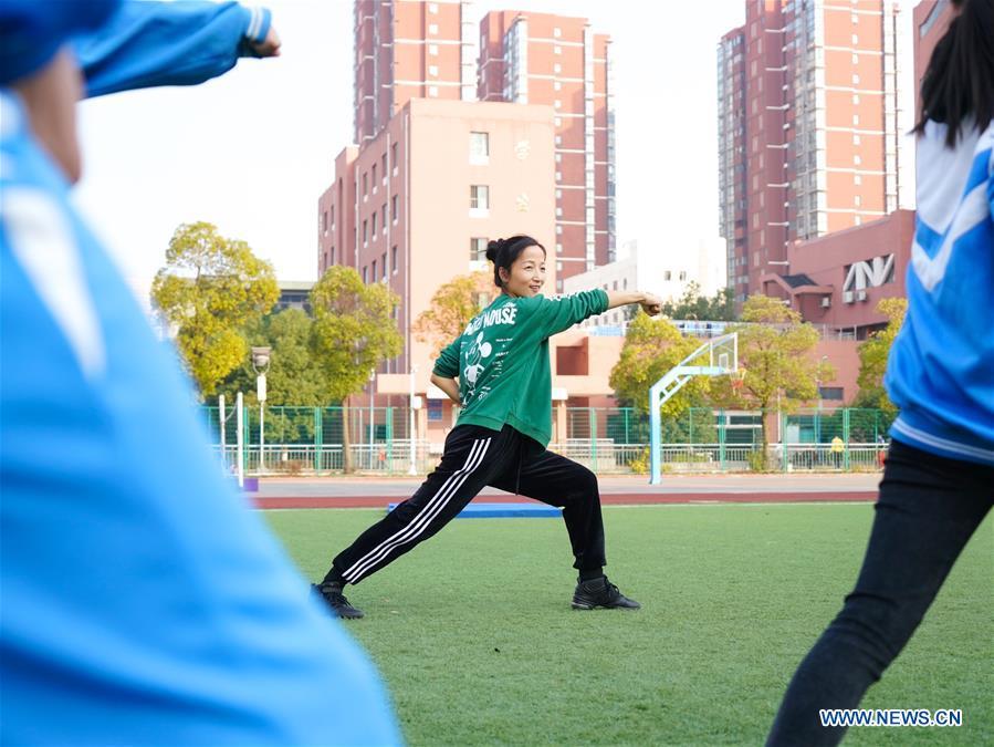 Teacher Zeng Wenping (C) instructs students in martial arts at Qiyin school in Nanchang, capital of east China\'s Jiangxi Province, Nov. 26, 2018. Zeng, 43, has been engaged in special education for 21 years ever since she graduated from university. Hearing impaired students enjoy the all-encompassing heartfelt and intensive care by Zeng and consider her as more than a teacher but a sister. (Xinhua/Hu Chenhuan)