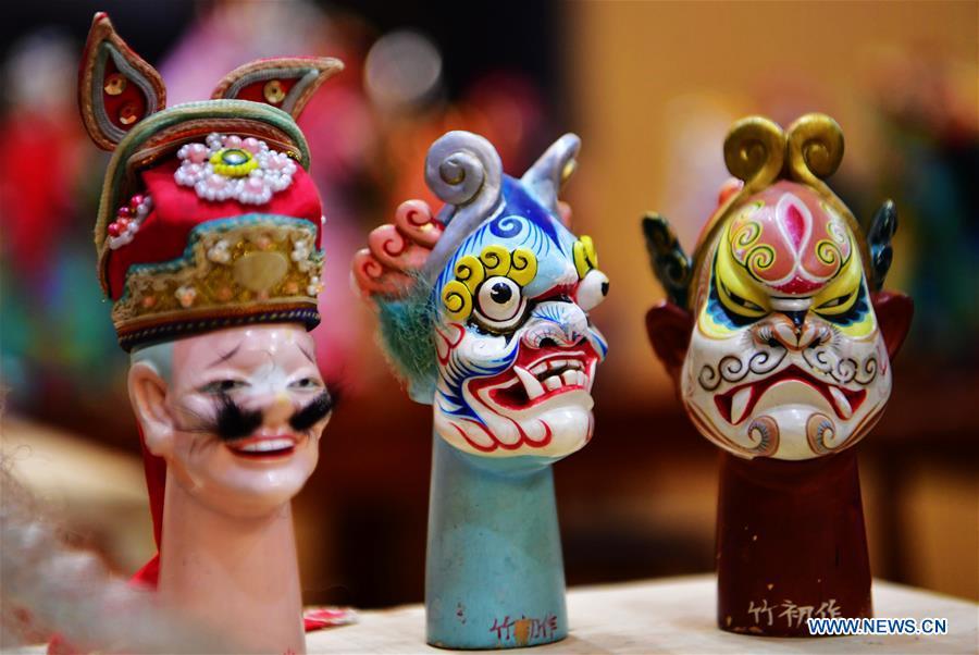 Photo taken on Nov. 28, 2018 shows wood puppet heads by Xu Zhuchu, a national-level intangible cultural heritage inheritor of Zhangzhou wood puppet head carving in Zhangzhou City, southeast China\'s Fujian Province. Listed as one of the national intangible cultural heritages in 2006, Zhangzhou wood puppet carving features exquisite craftsmanship. Xu\'s works of puppet head carving are known for rich and delicate facial expressions. Nowadays, Xu and his son, Xu Qiang, set up a studio of wood puppet to popularize local puppet culture. (Xinhua/Wei Peiquan)