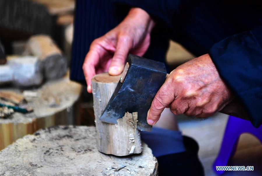 Xu Zhuchu, a national-level intangible cultural heritage inheritor of Zhangzhou wood puppet head carving, carves on a piece of wood to make puppet head at a studio in Zhangzhou City, southeast China\'s Fujian Province, Nov. 28, 2018. Listed as one of the national intangible cultural heritages in 2006, Zhangzhou wood puppet carving features exquisite craftsmanship. Xu\'s works of puppet head carving are known for rich and delicate facial expressions. Nowadays, Xu and his son, Xu Qiang, set up a studio of wood puppet to popularize local puppet culture. (Xinhua/Wei Peiquan)
