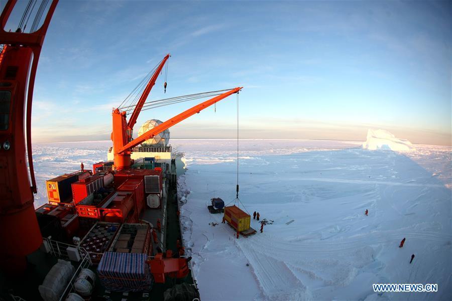 A crane unloads a container of supplies from China\'s research icebreaker Xuelong in Antarctica, Dec. 2, 2018. China\'s research icebreaker Xuelong, also known as the Snow Dragon, is now 44 kilometers away from the Zhongshan station. Unloading operations have been carried out after the routes were determined. (Xinhua/Liu Shiping)