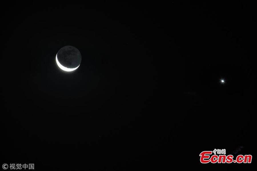 The moon hangs out nest to Venus in the sky of Beijing on Tuesday night, December 4, 2019. The crescent moon was just 3.6 degrees from Venus by twilight, appearing right next to each other to the naked eye.  (Photo/IC)