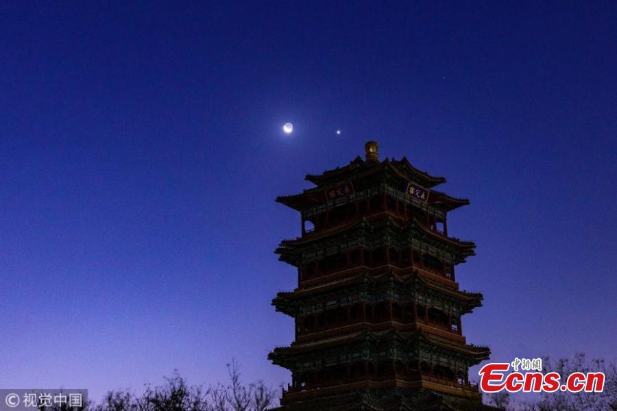 The moon hangs out next to Venus in the sky of Beijing on Tuesday night, December 4, 2019. The crescent moon was just 3.6 degrees from Venus by twilight, appearing right next to each other to the naked eye.  (Photo/IC)