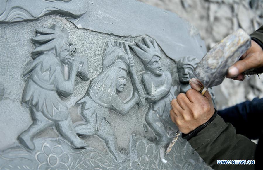 A handicraftsman processes a rock carving work in Longdong Village of Xuan\'en County in Enshi Tujia and Miao Autonomous Prefecture, central China\'s Hubei Province, Dec. 5, 2018. Residents here benefit from the rich rock resources and turn plain rocks into delicate artworks. (Xinhua/Song Wen)