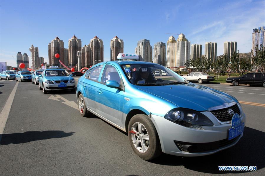 The first batch of new energy taxis are put into operation in Dalian, northeast China\'s Liaoning Province, Oct. 26, 2010. China has been delivering on its commitment to the international community on climate change by continuously shifting to a more green economy over the past years. New energy-rich regions like Inner Mongolia and Ningxia are sending more electricity generated from clean energy to the country\'s bustling east to help reduce the country\'s heavy reliance on coal in the fight against pollution and coping with climate change. China is also a leader in new energy vehicles (NEVs), with many regions across the country moving to replace their traditional gasoline-powered buses and taxis with green-energy vehicles. The country has been the world\'s largest NEV market for three consecutive years, with some 777,000 NEVs sold in 2017 alone. Sales in the first 10 months of this year jumped 75.6 percent year on year to 860,000 units. Thanks to increased investment in green energy, China\'s carbon intensity, or the amount of carbon dioxide emissions per unit of GDP, in 2017 had declined by 46 percent from 2005 levels, meeting the target ahead of schedule of a 40-45 percent drop by 2020, according to the Chinese Ministry of Ecology and Environment. (Xinhua/Zhang Chunlei)