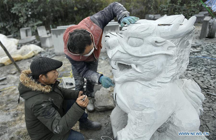 Two handicraftsmen process a rock carving work in Longdong Village of Xuan\'en County in Enshi Tujia and Miao Autonomous Prefecture, central China\'s Hubei Province, Dec. 5, 2018. Residents here benefit from the rich rock resources and turn plain rocks into delicate artworks. (Xinhua/Song Wen)