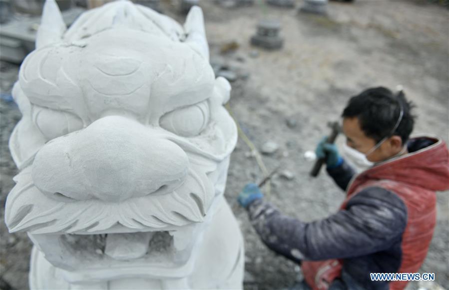 A handicraftsman processes a rock carving work in Longdong Village of Xuan\'en County in Enshi Tujia and Miao Autonomous Prefecture, central China\'s Hubei Province, Dec. 5, 2018. Residents here benefit from the rich rock resources and turn plain rocks into delicate artworks. (Xinhua/Song Wen)