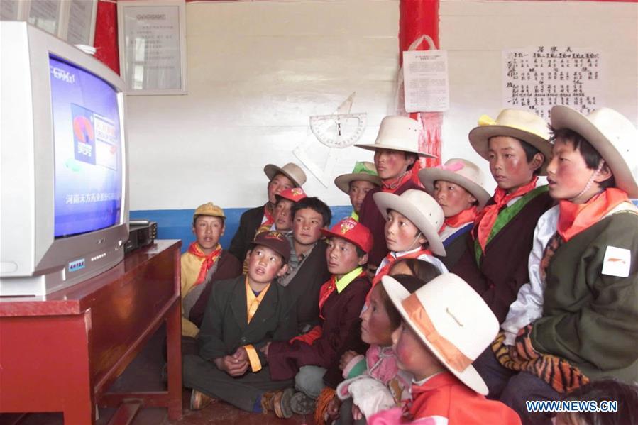 Pupils watch a TV for the first time thanks to the \