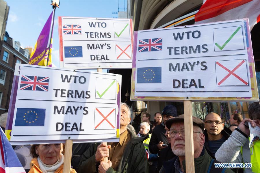 Demonstrators hold placards in the \