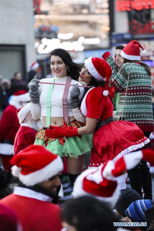 Revelers take part in the 2018 SantaCon in New York, the United States, Dec. 8, 2018. Dressed as Santa Claus or in festive costumes, hundreds of People participated in the 2018 SantaCon on Saturday, enjoying the Christmas atmosphere and raising money for charity. (Xinhua/Wang Ying)