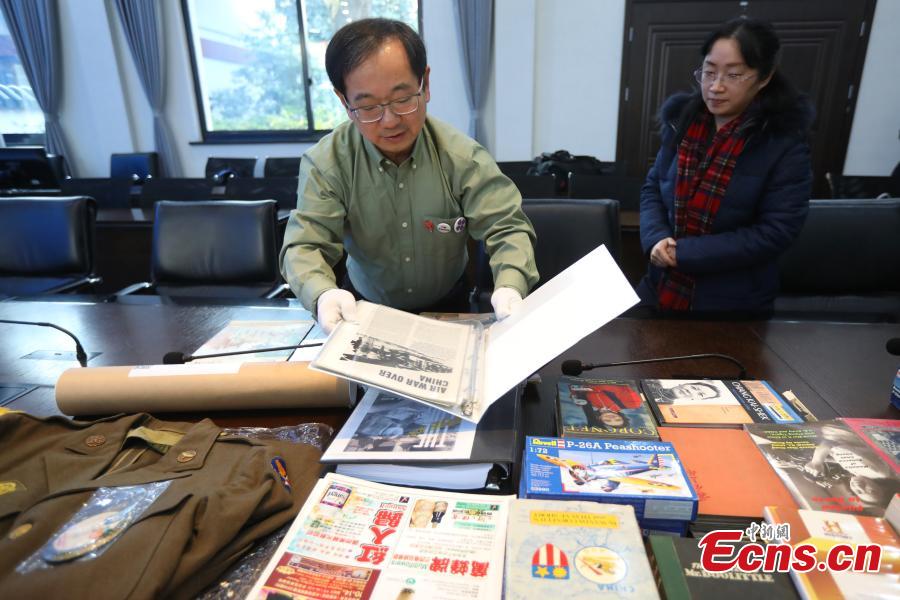 Chinese-American Lu Zhaoning donates historical materials to the Memorial Hall of the Aviator Martyrs in the War of Resistance against Japanese Aggression in Nanjing City, Jiangsu Province, Dec. 14, 2018. The relics included pilot’s suits, books by Flying Tiger pilots and other materials about WWII war planes. Lu’s relative Lu Meiyin served as a flight attendant in the war. The memorial hall shows the names and a basic introduction in Chinese, English and Russian on thousands of pilots from China, the United States and Soviet Union who died in China during the war. (Photo: China News Service/Yang Bo)