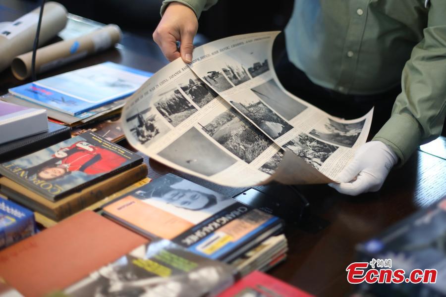 Chinese-American Lu Zhaoning donates historical materials to the Memorial Hall of the Aviator Martyrs in the War of Resistance against Japanese Aggression in Nanjing City, Jiangsu Province, Dec. 14, 2018. The relics included pilot’s suits, books by Flying Tiger pilots and other materials about WWII war planes. Lu’s relative Lu Meiyin served as a flight attendant in the war. The memorial hall shows the names and a basic introduction in Chinese, English and Russian on thousands of pilots from China, the United States and Soviet Union who died in China during the war. (Photo: China News Service/Yang Bo)