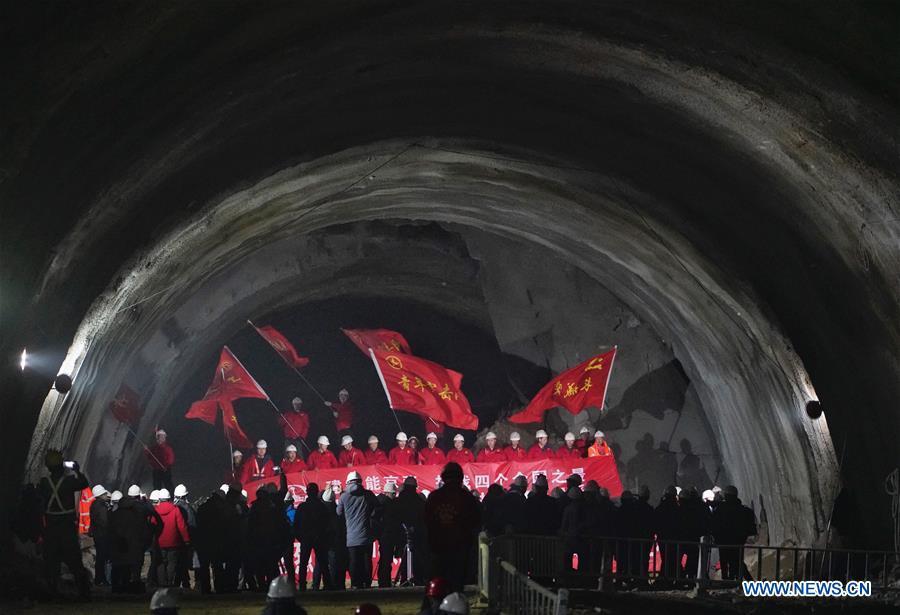 Workers celebrate as they cut through the New Badaling tunnel of the Beijing-Zhangjiakou high-speed rail line in Beijing, capital of China, Dec. 13, 2018. Workers have achieved a major breakthrough in the Beijing-Zhangjiakou high-speed rail line project, after they dug through the New Badaling tunnel, a pivotal part along the line, on Thursday. (Xinhua/Xing Guangli)