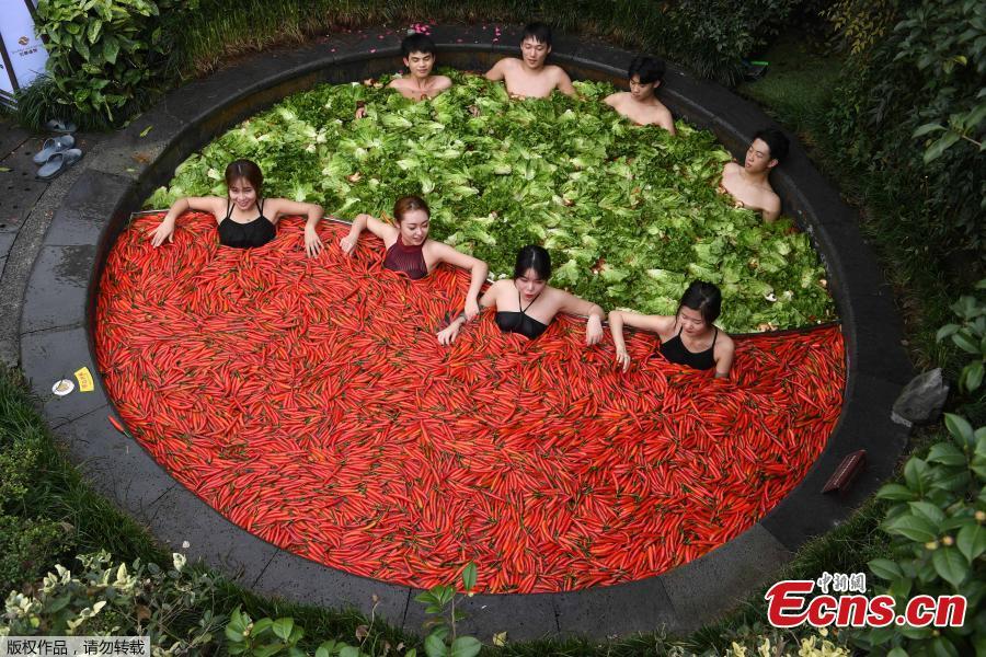 A group of people enjoy hotpots while soaking in a hotpot-style hot spring in the city of Hangzhou in Zhejiang Province, December 16, 2018. The hot spring designed as \