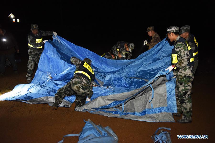 Rescuers set up makeshift tents in Zhoujia Township after a 5.7 magnitude earthquake hit Xingwen County, southwest China\'s Sichuan Province, Dec. 16, 2018. China\'s emergency regulator on Sunday initiated a national emergency response to a magnitude 5.7 earthquake in southwest China\'s Sichuan Province. The earthquake hit the county of Xingwen in the city of Yibin, Sichuan Province, at 12:46 p.m. Sunday, with a depth of 12 km, according to the local government. By 5:30 p.m. Sunday, 16 people had been reported injured in the earthquake, the ministry said. (Xinhua/Zhang Kefan)