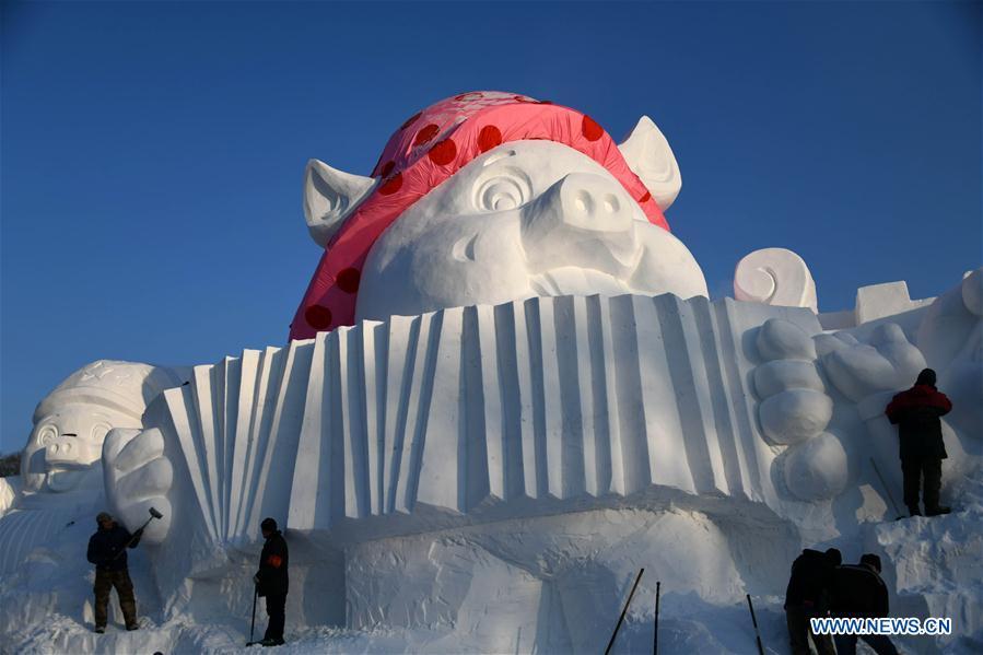 Sculptors carve a snow sculpture with \