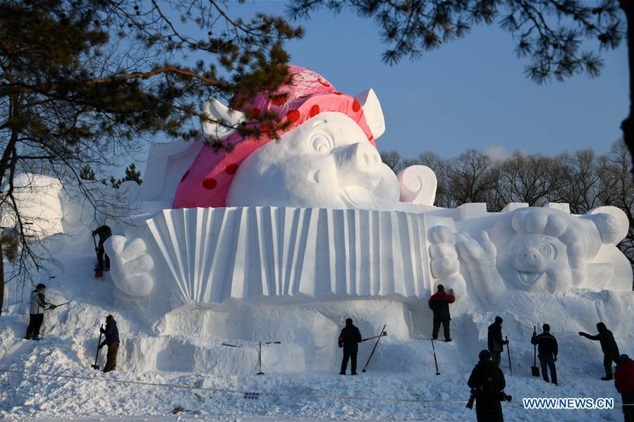 Sculptors carve a snow sculpture with \
