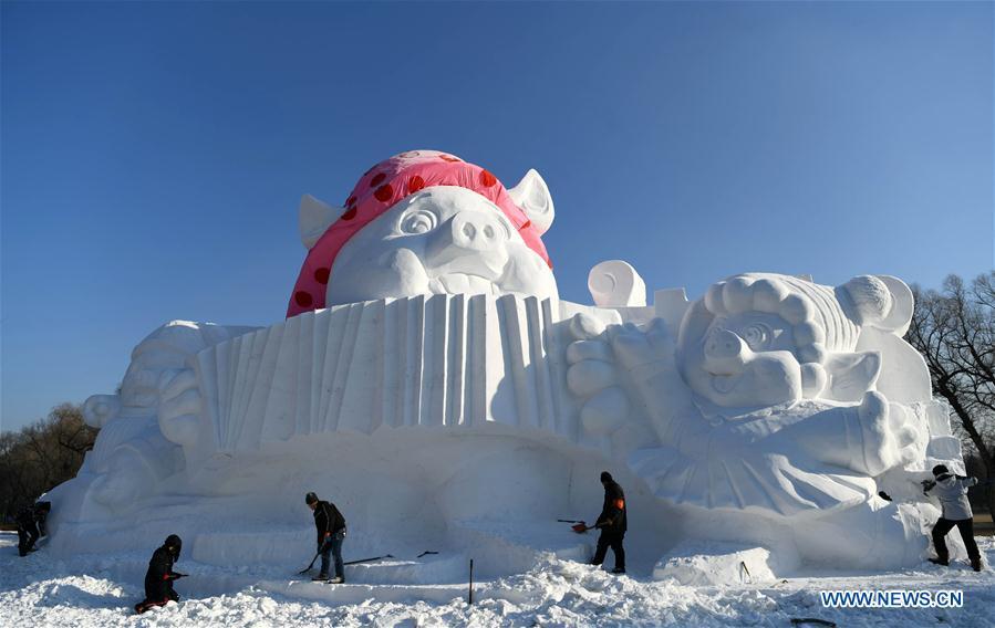 Sculptors carve a snow sculpture with \