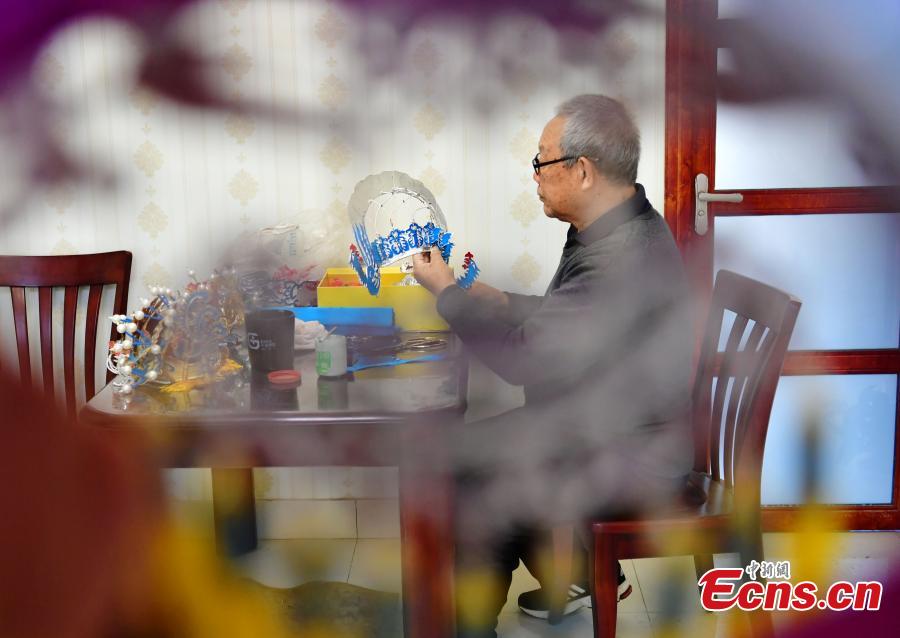 Now in his seventies, Zhou Genglan shows his handmade headpieces used in traditional operas in Shijiazhuang City, North China\'s Hebei Province, Dec. 18, 2018. Traditional headdresses had significant historical and cultural meaning in operas. (Photo: China News Service)