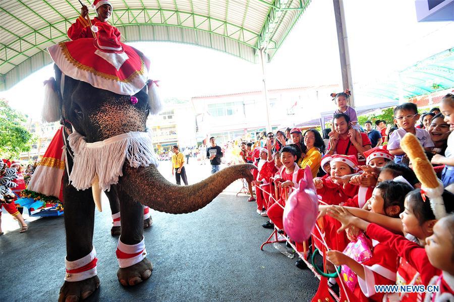 An elephant distributes gifts to students during Christmas celebrations at a school in Ayutthaya province, Thailand, Dec. 24, 2018. The annual event is held to celebrate Christmas and promote tourism in Ayutthaya. (Xinhua/Rachen Sageamsak)
