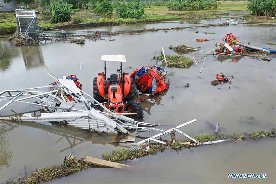 Farmland and farm machines are damaged by tsunami in Banten Province, in Indonesia, Dec. 24, 2018. The Indonesian disaster agency on Monday put the death toll of the tsunami triggered by a volcanic eruption at 373 with 1,459 others injured, a spokesman of the agency told Xinhua on Monday. (Xinhua/Du Yu)